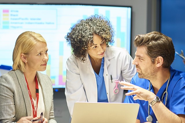 3 people in front of a computer